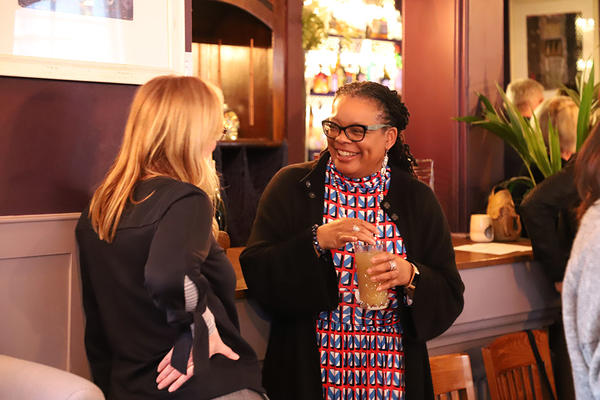 Two women smiling at an event